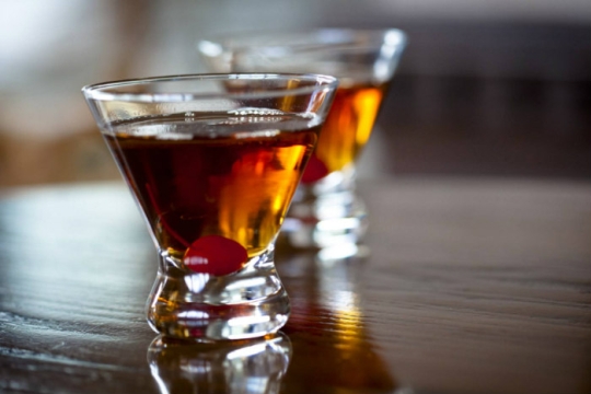 Hamanhattan cocktail with a maraschino cherry in the bottom
